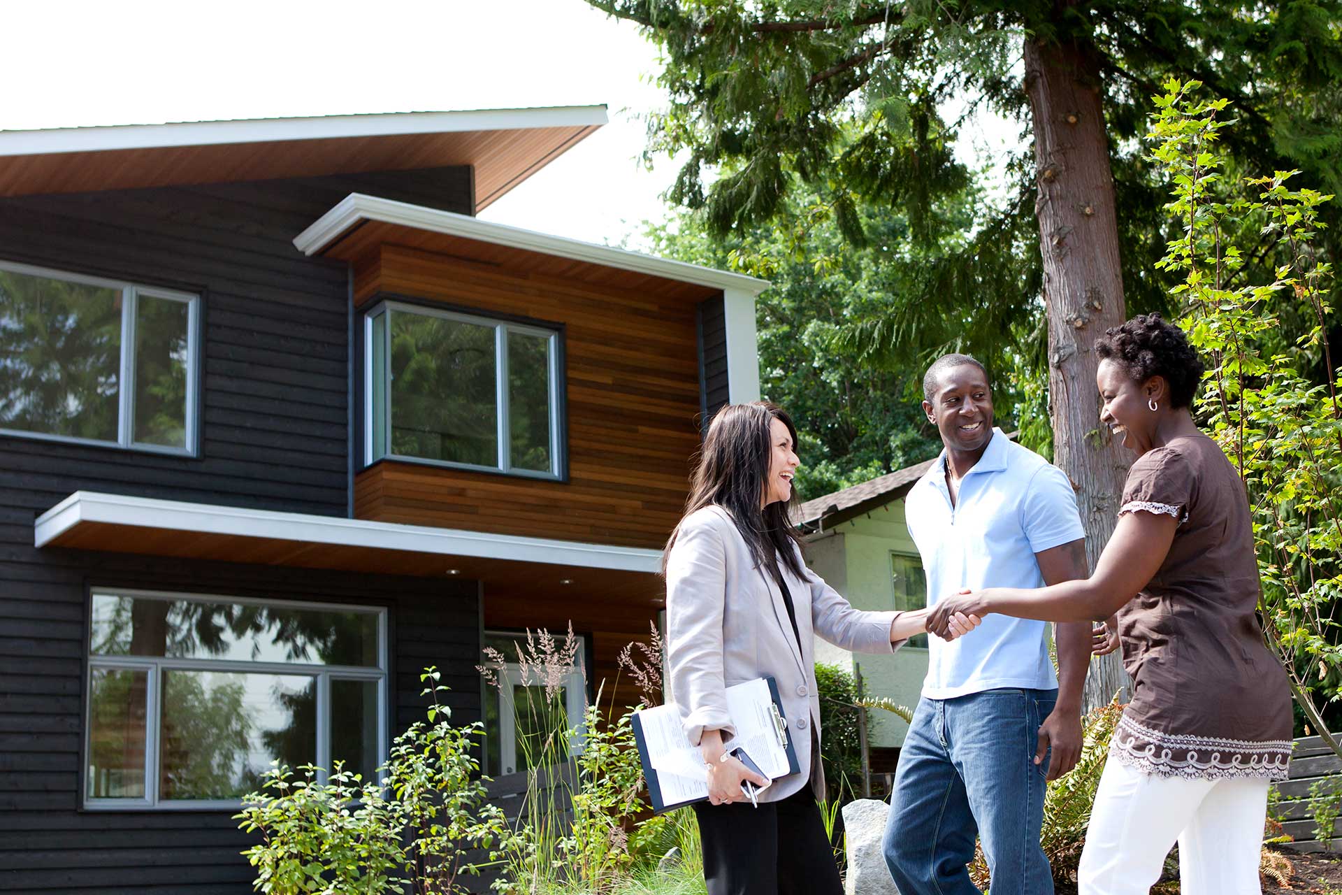 Couple meeting real estate agent.