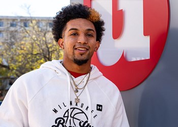 Badgers basketball point guard and member Chucky Hepburn poses outside a UWCU branch.