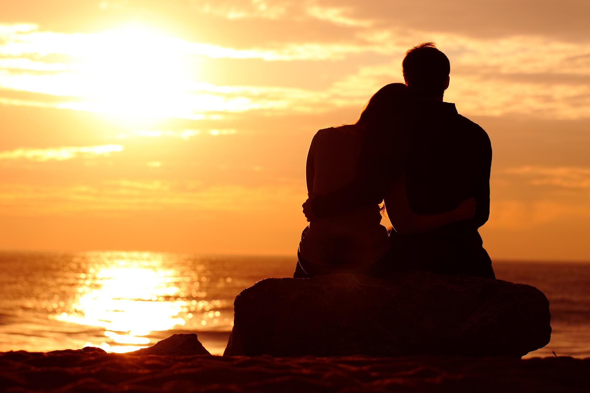 Couple enjoying a sunset on vacation.