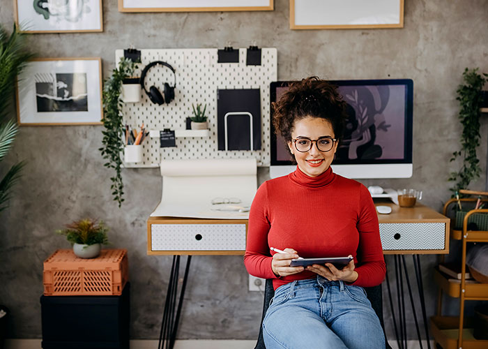 Woman a tablet to learn investment tips from UW Credit Union