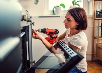 Women performing home repairs.