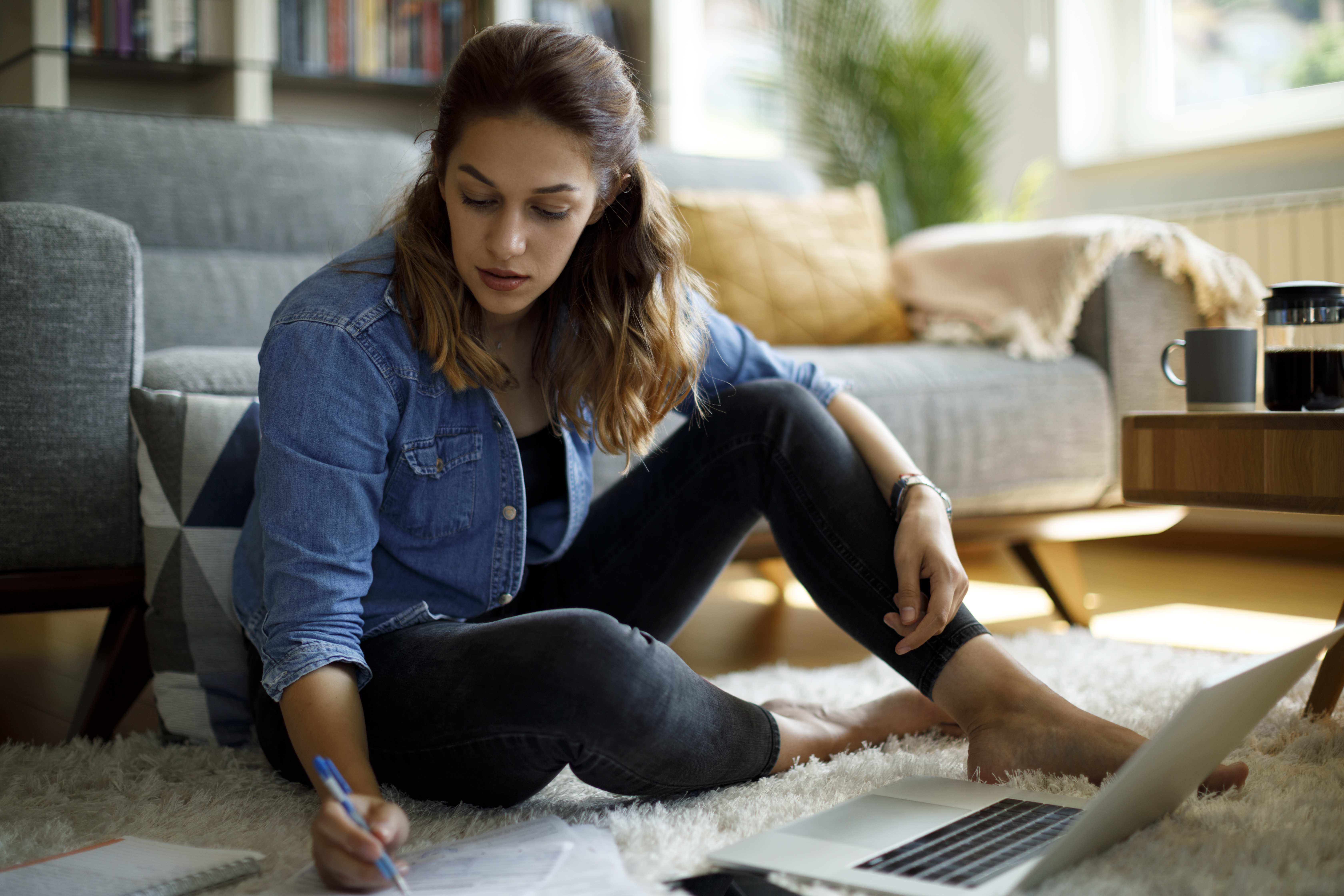 A woman goes over credit card statements as she works to build credit and a healthier relationship with her finances.