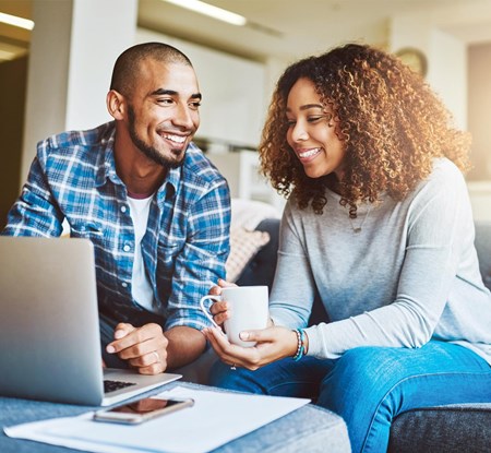 Couple at the sofa with laptop