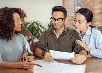 Couple meets with financial advisor to discuss finances.