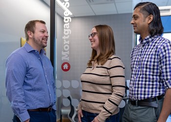 Rachel Lien and her husband are pictured with Erik Julson, member of the Multifamily Residential Business Lending team at UW Credit Union