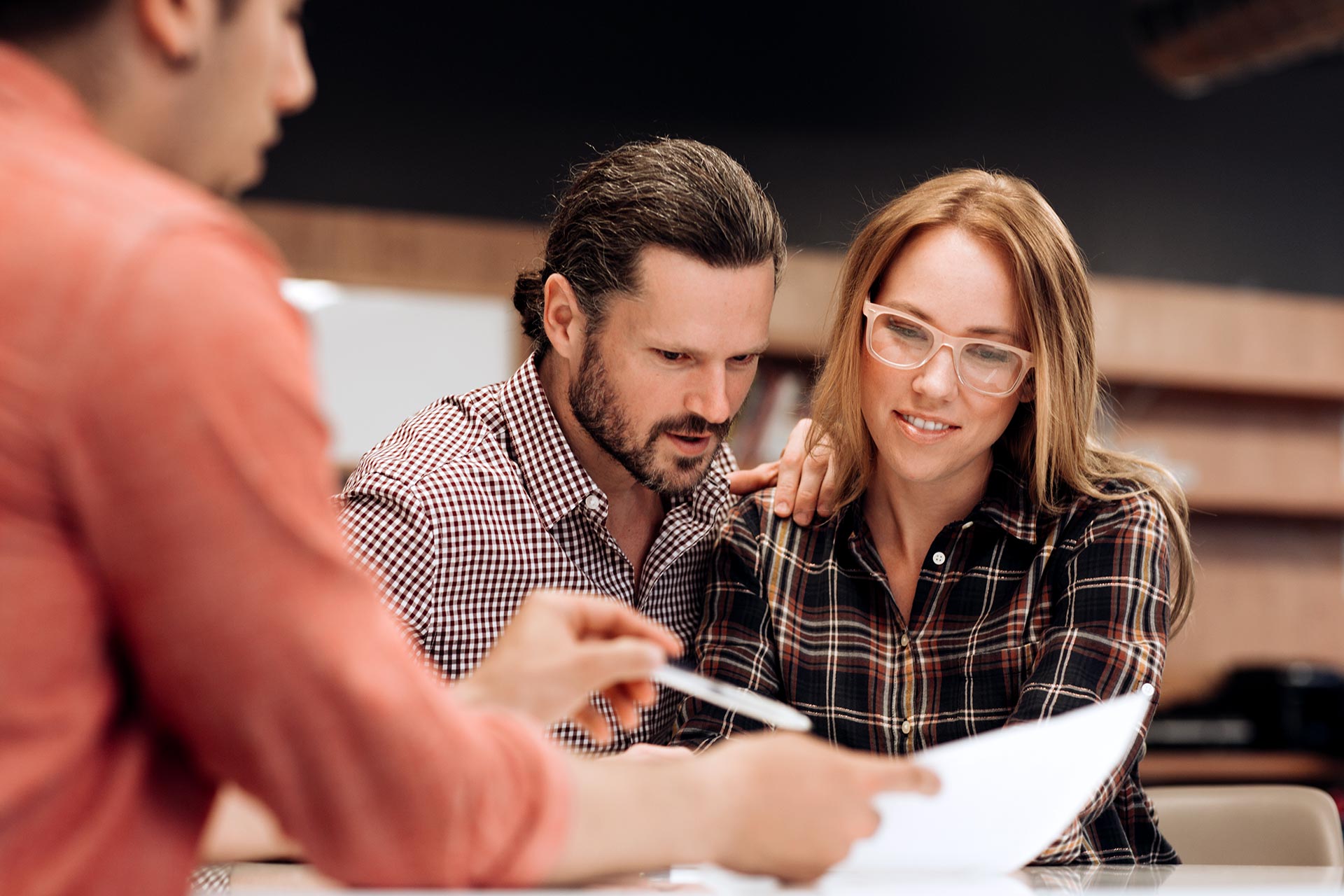 Couple discusses mortgages with lender.