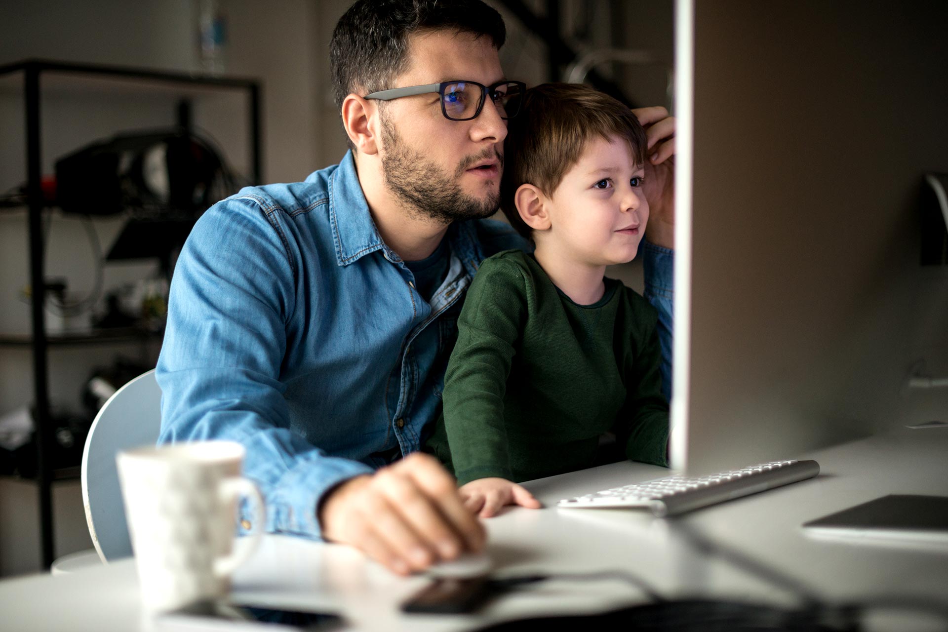 Father and son looking at computer.